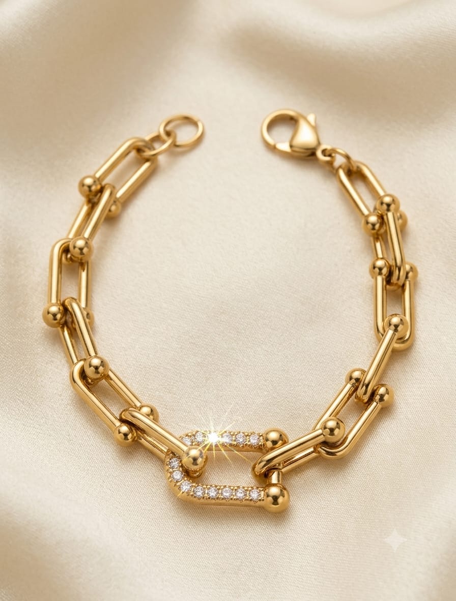 Bracciale a catena in acciaio dorato con elemento centrale in cristalli