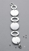 Bracciale in acciaio argentato con dischi e anelli alternati